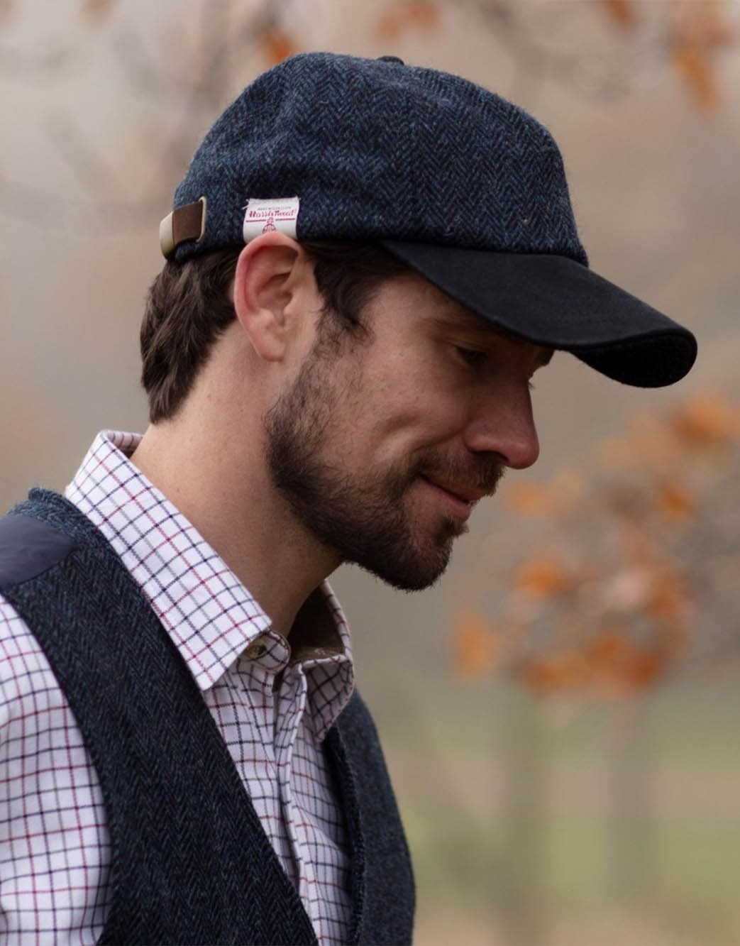 Walker and Hawkes Brungton Harris Tweed Baseball Cap met Suède Leren Klep
